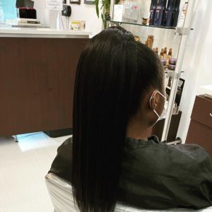 24 in wavy extensions in a sleek ponytail amoy couture NY